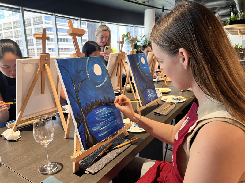 Woman painting a night landscape